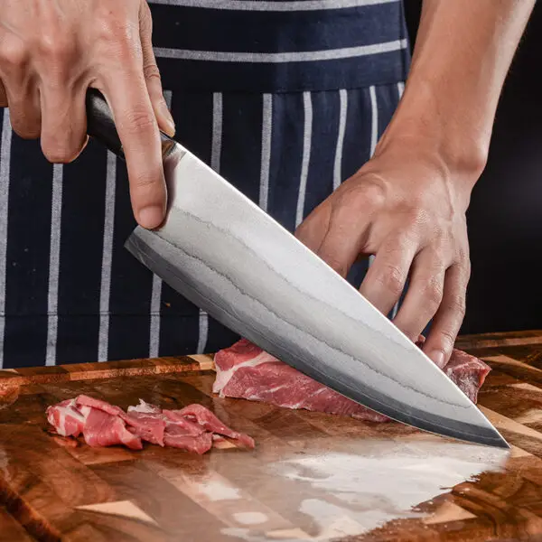 Detailed shot of the Chef's Knife – 6-Layer Composite Steel Blade, showing the spine thickness and blade height for enhanced cutting performance.