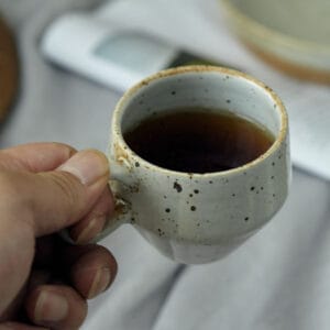 Shino yaki coffee cup featuring a handmade glazed finish and Japanese-inspired form.