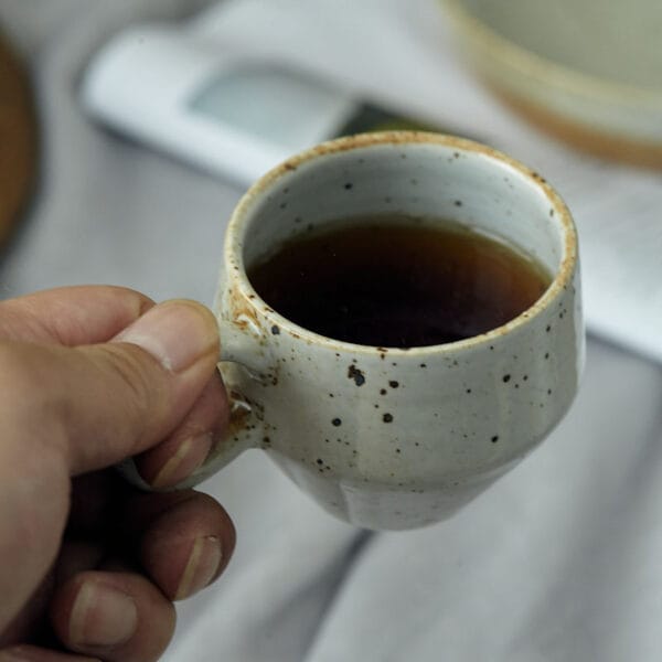 Shino yaki coffee cup featuring a handmade glazed finish and Japanese-inspired form.