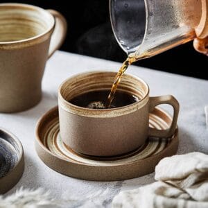 Stoneware coffee cup and saucer set with a smooth natural glaze, perfect for everyday use