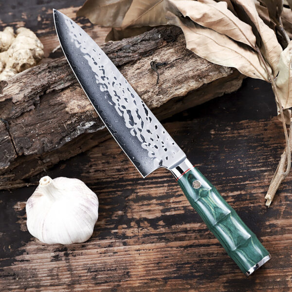 Close-up of the 32.5cm Gyoto chef’s knife showing its double bevel edge and wooden handle.