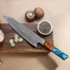 20cm Damascus Japanese chef knife with blue octagonal resin handle on cutting board