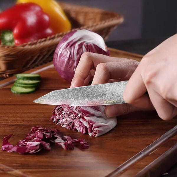 Close-up of a Damascus steel knife blade, showcasing its intricate patterns and 58-60 HRC hardness.