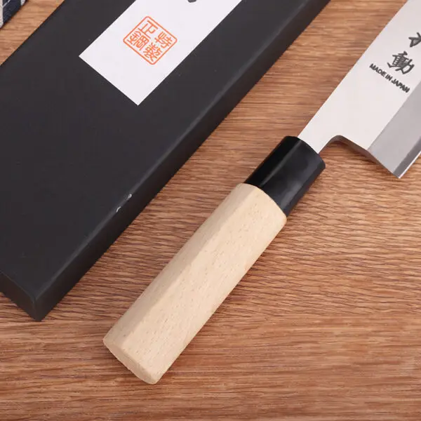 Wooden handle and 400 series stainless steel blade of a 21cm Deba knife, showcasing traditional craftsmanship.