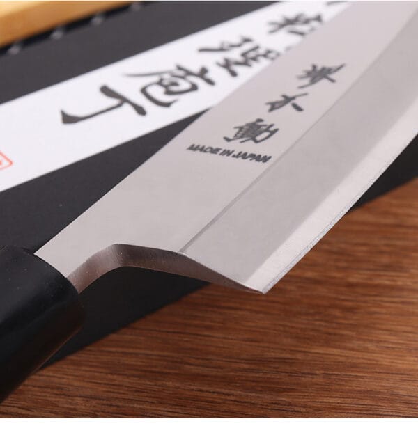 Close-up of the single-bevel edge on a 21cm Deba knife, designed for precision cutting
